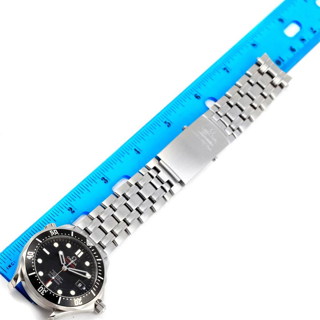 The image shows an Omega Seamaster 212.30.41.20.01.002 Men
s Stainless Steel Black Dial 212.30.41.20.01.002 Men
s Stainless Steel Black Dial watch laid flat with its stainless steel bracelet alongside a blue measuring ruler.