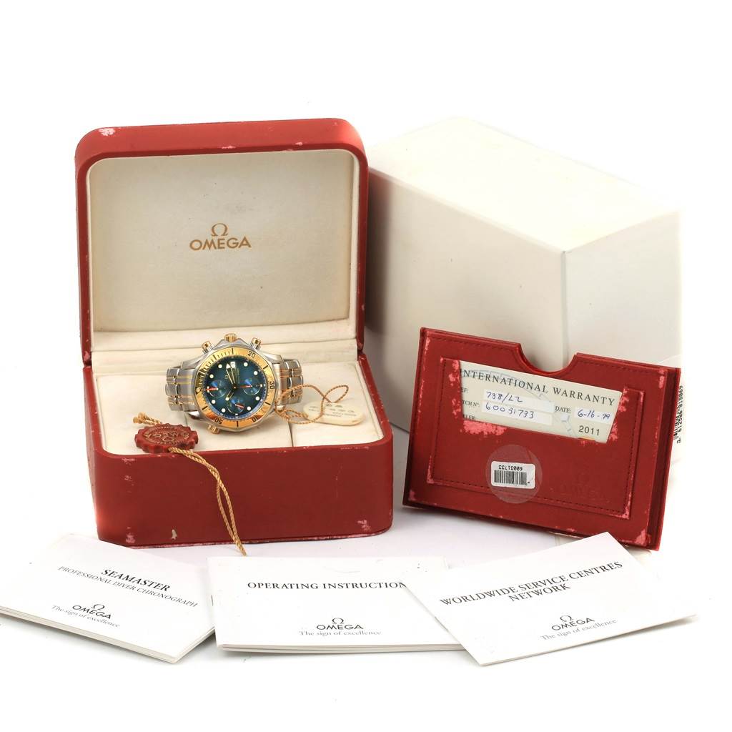 The Omega Seamaster 2398.80.00 Men's Steel and Gold (two tone) Blue Dial 2398.80.00 Men's Steel and Gold (two tone) Blue Dial watch is shown in its open box with booklets, warranty card, and tag displayed around it.