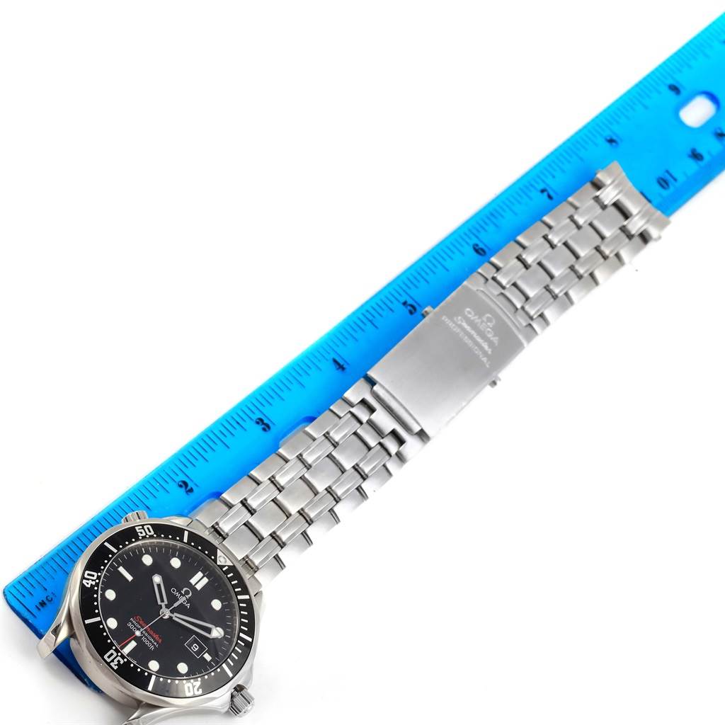 The Omega Seamaster 212.30.41.61.01.001 Men
s Stainless Steel Black Dial 212.30.41.61.01.001 Men
s Stainless Steel Black Dial watch is shown from a top-down angle, displaying the face, bezel, stainless steel bracelet, and clasp next to a ruler.