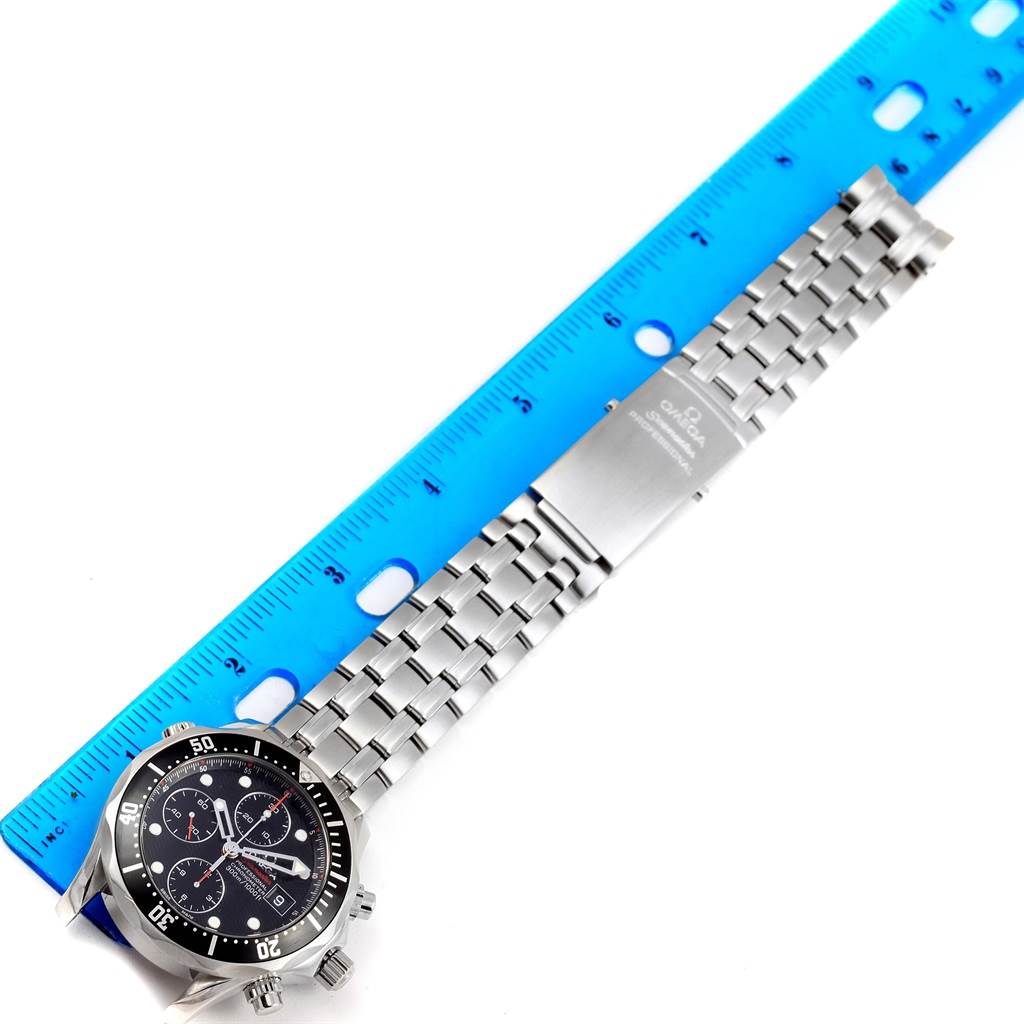 The Omega Seamaster 213.30.42.40.01.001 Men
s Stainless Steel Black Dial 213.30.42.40.01.001 Men
s Stainless Steel Black Dial watch is shown from a top view, displaying its face, bezel, and full metal bracelet against a blue ruler.