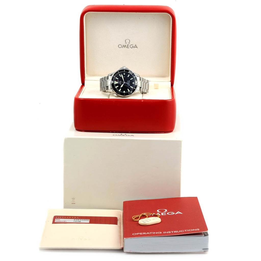The image shows an Omega Seamaster 2264.50.00 Men
s Stainless Steel Black Dial 2264.50.00 Men
s Stainless Steel Black Dial watch in its red case, along with the operating instructions and warranty card.