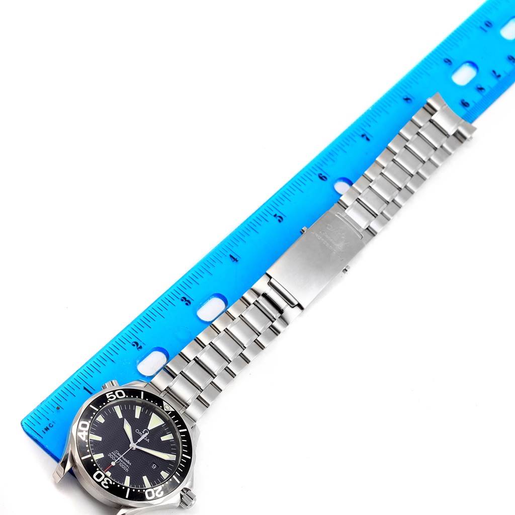 The image shows an Omega Seamaster 2264.50.00 Men
s Stainless Steel Black Dial 2264.50.00 Men
s Stainless Steel Black Dial watch laid out flat next to a ruler, displaying the watch face and metal bracelet.