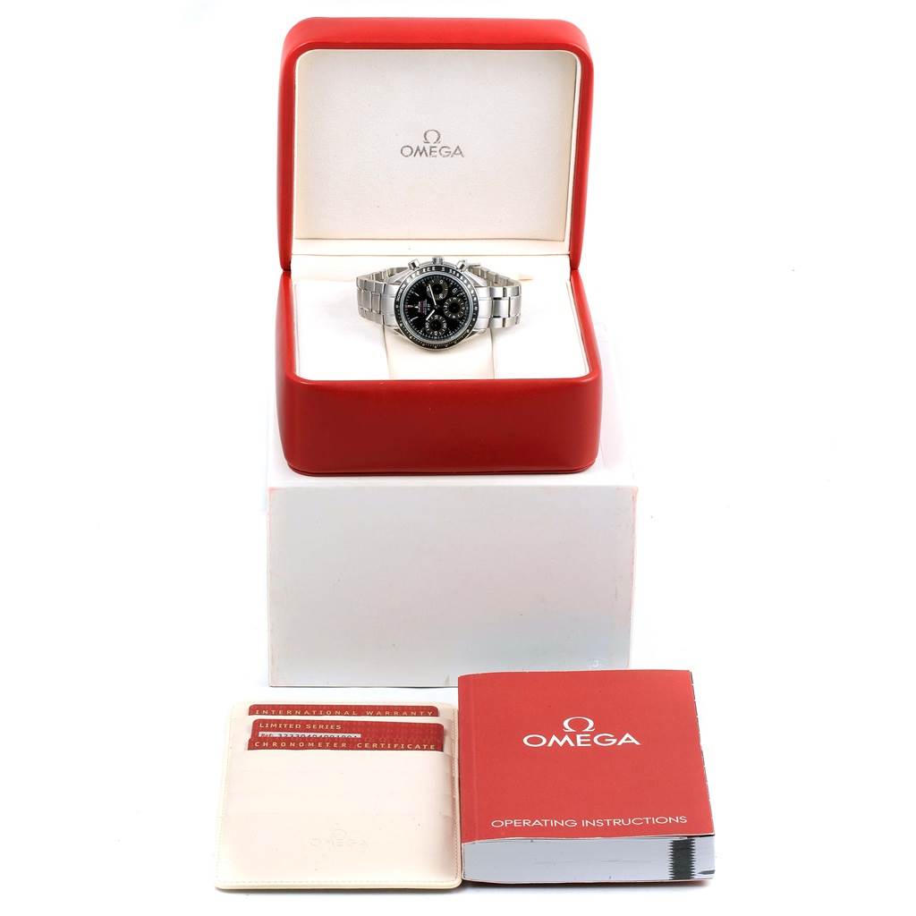 The Omega Seamaster 323.30.40.40.01.001 Men's Stainless Steel Black Dial 323.30.40.40.01.001 Men's Stainless Steel Black Dial watch is shown in an open red display box, with operating instructions and warranty cards positioned in front of it.