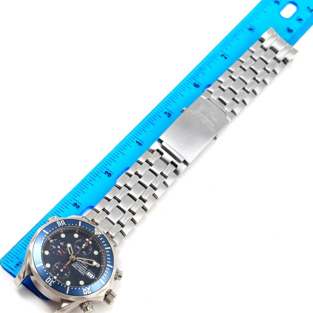 The image shows an Omega Seamaster 2599.80.00 Men
s Stainless Steel Blue Dial 2599.80.00 Men
s Stainless Steel Blue Dial watch, featuring its face, bezel, and metal bracelet placed beside a ruler for scale.