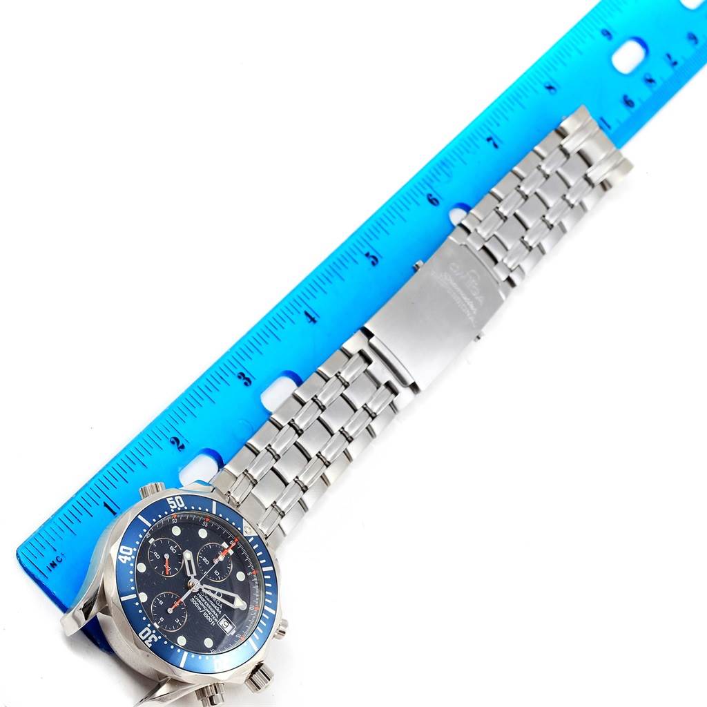 The image shows an Omega Seamaster 2599.80.00 Men
s Stainless Steel Blue Dial 2599.80.00 Men
s Stainless Steel Blue Dial watch with its bracelet extended next to a blue ruler for measurement.