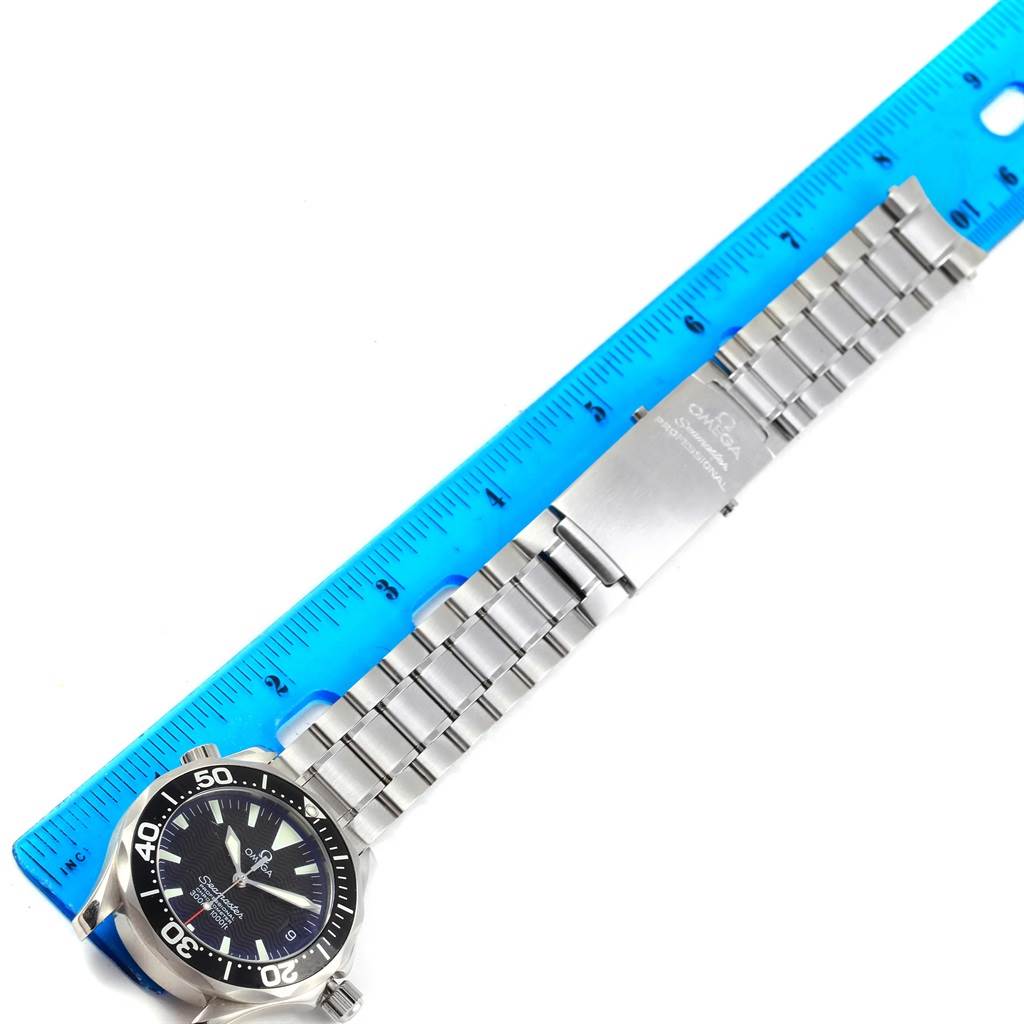 The image shows an Omega Seamaster 2252.50.00 Men's Stainless Steel Black Dial 2252.50.00 Men's Stainless Steel Black Dial watch laid flat next to a ruler, displaying the watch face, metal bracelet, and clasp.