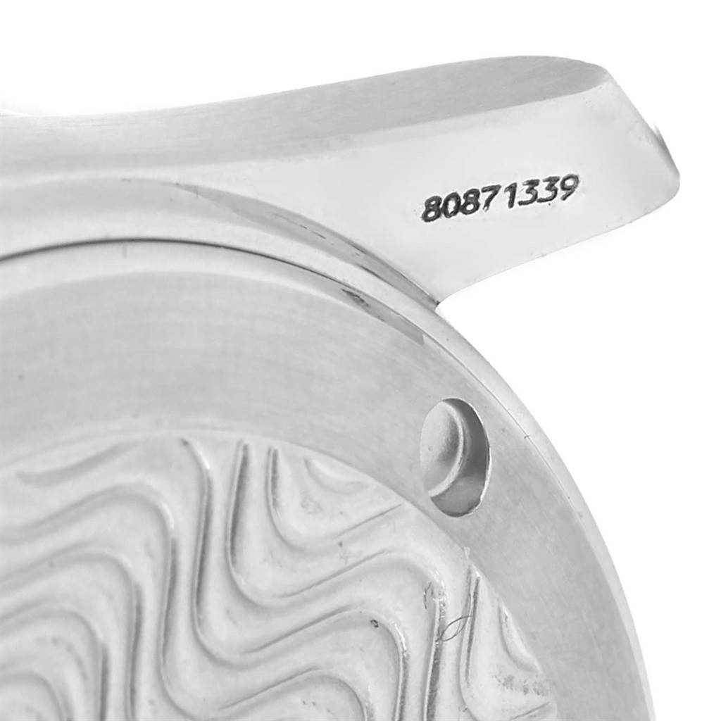 The image shows a close-up of the Omega Seamaster Men
s Stainless Steel Black Dial Men
s Stainless Steel Black Dial watch
s case serial number, focusing on the lug and part of the wave-patterned dial.