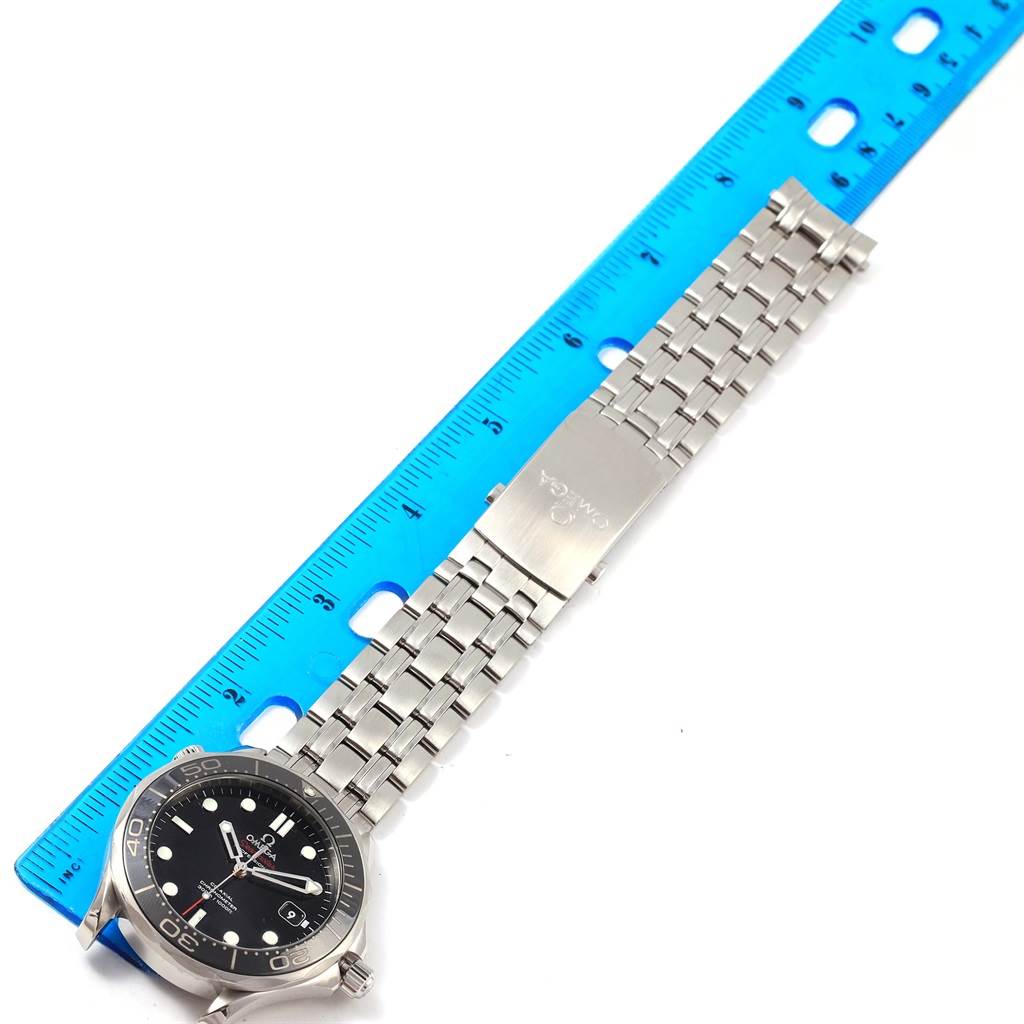 The image shows an Omega Seamaster 212.30.41.20.01.003 Men
s Stainless Steel Black Dial 212.30.41.20.01.003 Men
s Stainless Steel Black Dial watch laying flat, with the face, bezel, and metal bracelet visible alongside a ruler.