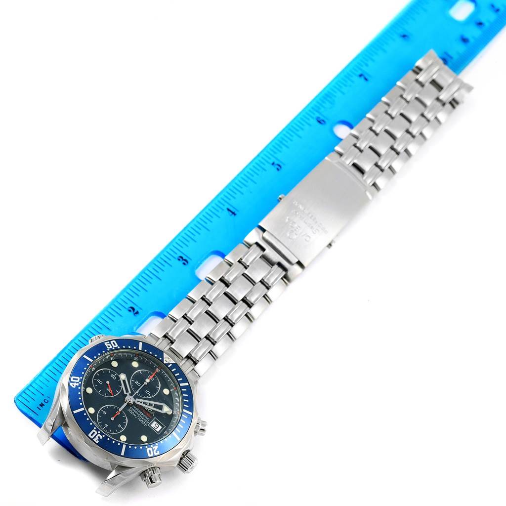 The Omega Seamaster 2599.80.00 Men
s Stainless Steel Blue Dial 2599.80.00 Men
s Stainless Steel Blue Dial watch is shown at a slight angle, featuring its face and stainless steel bracelet laid beside a blue ruler.