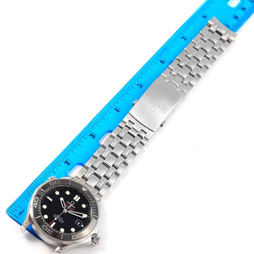 The Omega Seamaster 212.30.41.20.01.003 Men
s Stainless Steel Black Dial 212.30.41.20.01.003 Men
s Stainless Steel Black Dial watch is shown from a top-down angle with the face and full metal bracelet visible next to a blue ruler.