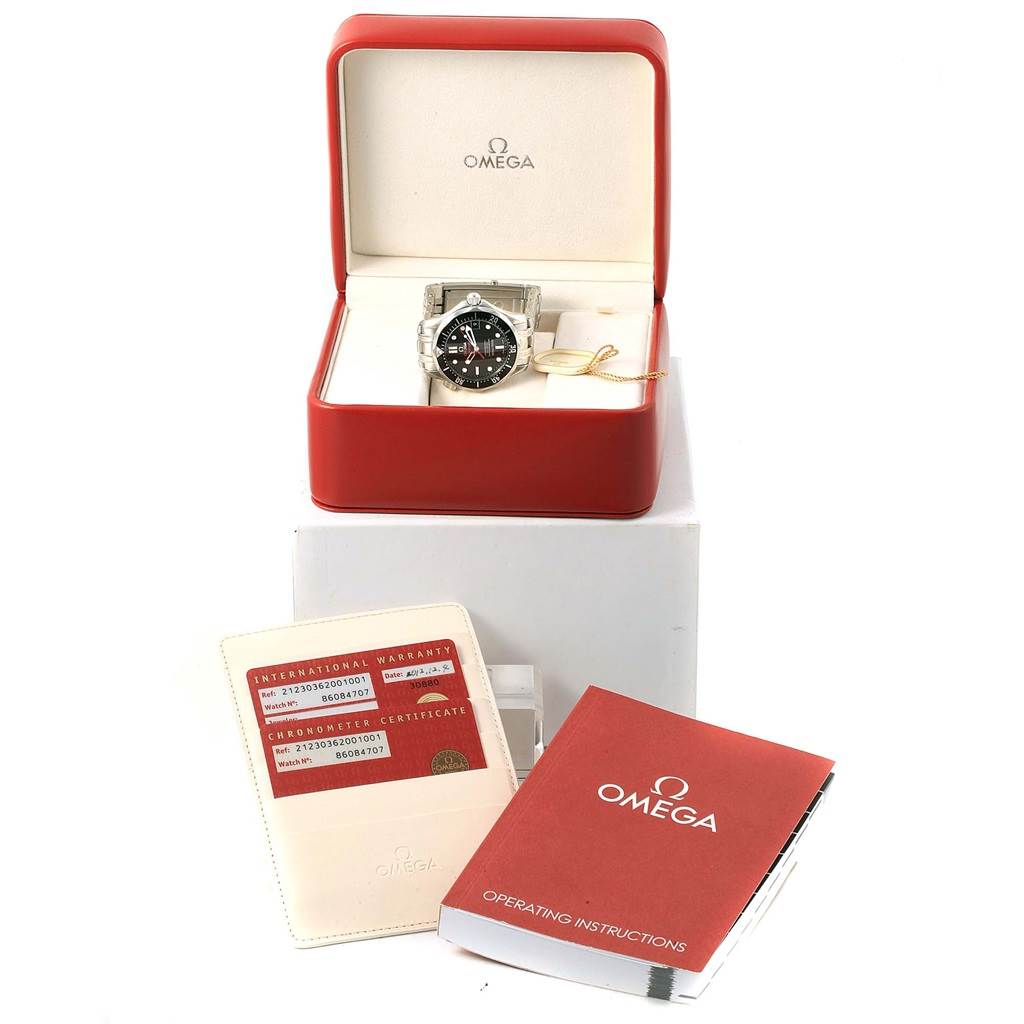 The Omega Seamaster 212.30.36.20.01.001 Men's Stainless Steel Black Dial 212.30.36.20.01.001 Men's Stainless Steel Black Dial watch is shown in its open box alongside warranty cards and an operating instructions booklet.