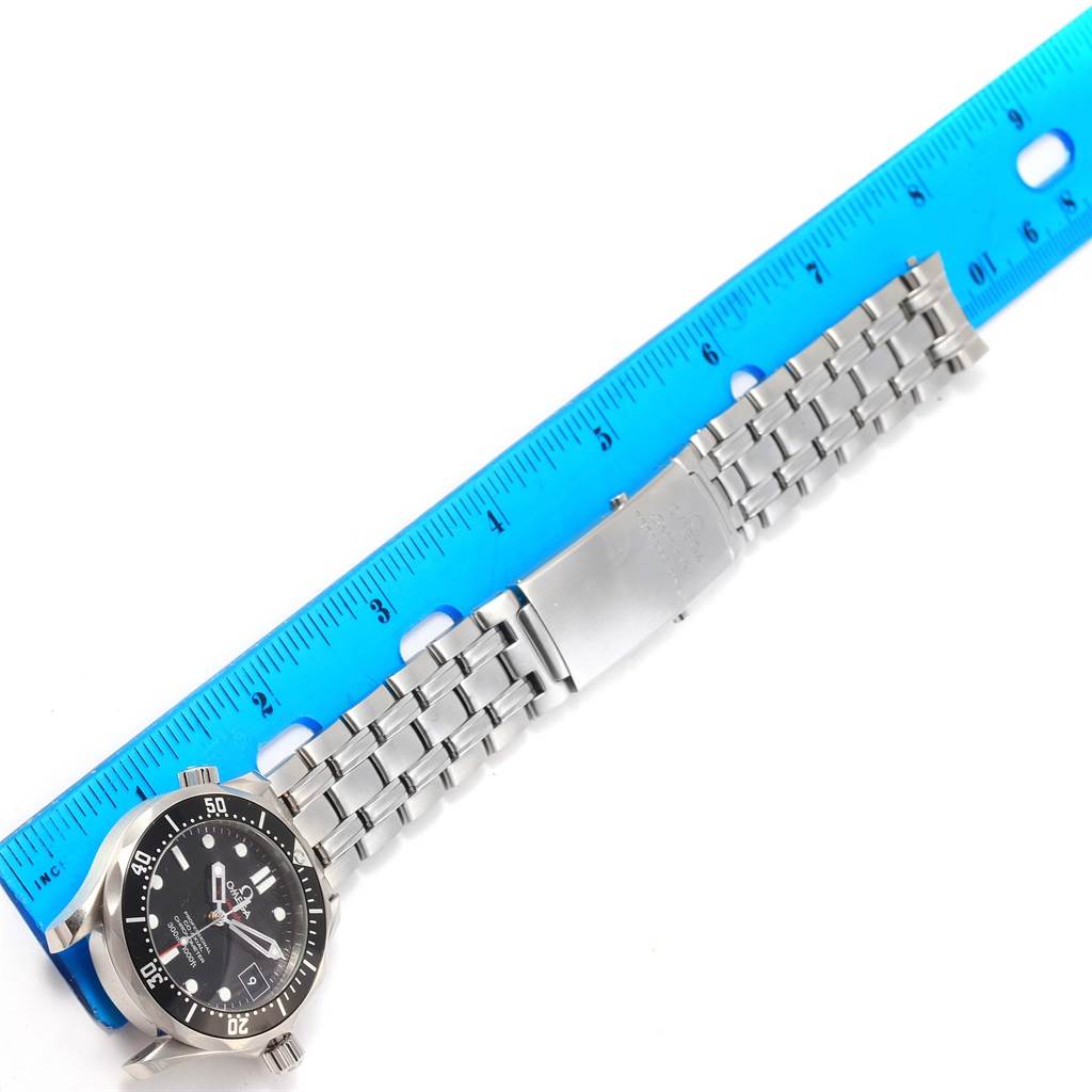 The image shows an Omega Seamaster 212.30.36.20.01.001 Men's Stainless Steel Black Dial 212.30.36.20.01.001 Men's Stainless Steel Black Dial watch laid flat with a blue ruler above the metal bracelet for measurement.