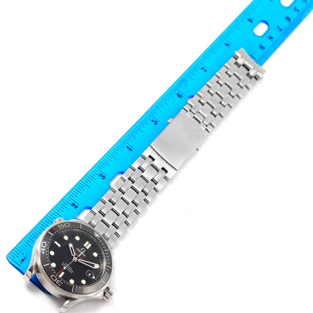 The Omega Seamaster 212.30.41.20.01.003 Men
s Stainless Steel Black Dial 212.30.41.20.01.003 Men
s Stainless Steel Black Dial watch is shown lying flat and angled slightly to the left, alongside a blue ruler for size reference.