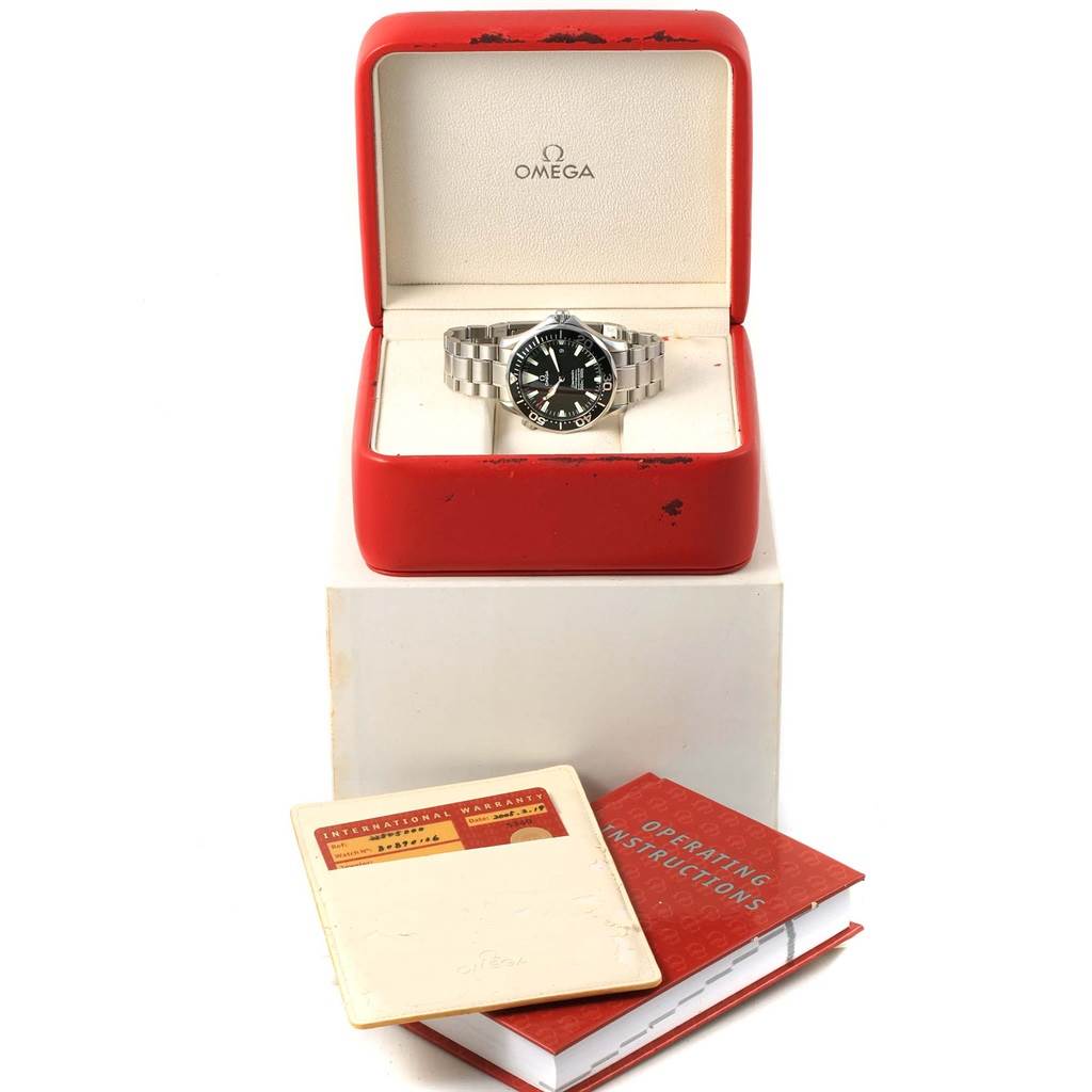 The Omega Seamaster 2254.50.00 Men
s Stainless Steel Black Dial 2254.50.00 Men
s Stainless Steel Black Dial watch is displayed in an open red box, with instruction manuals and a warranty booklet shown in front.