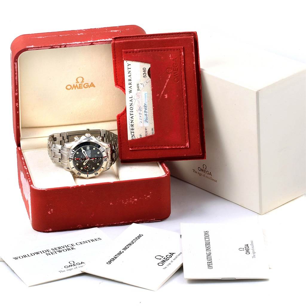 The image shows an Omega Seamaster 2598.80.00 Men
s Stainless Steel Blue Dial 2598.80.00 Men
s Stainless Steel Blue Dial watch from a front angle in its red box, alongside warranty card and booklets.