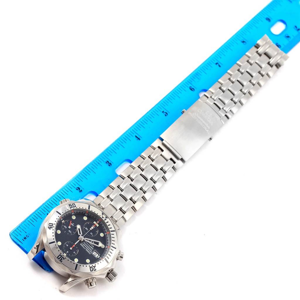 This image shows the Omega Seamaster 2598.80.00 Men
s Stainless Steel Blue Dial 2598.80.00 Men
s Stainless Steel Blue Dial watch laid flat next to a ruler, displaying the face, bezel, and bracelet.