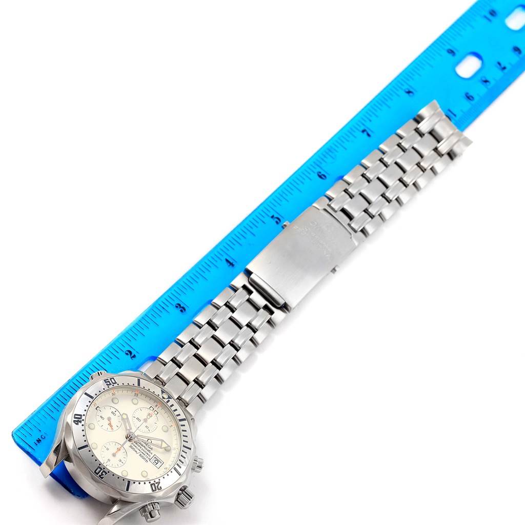 The image shows a top view of the Omega Seamaster 2598.20.00 Men
s Stainless Steel White Dial 2598.20.00 Men
s Stainless Steel White Dial watch, displaying the face, bezel, and stainless steel bracelet next to a blue ruler.