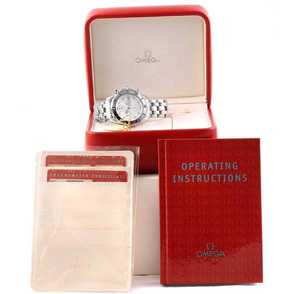 The image shows an Omega Seamaster 2598.20.00 Men
s Stainless Steel White Dial 2598.20.00 Men
s Stainless Steel White Dial watch in its case, accompanied by an operating instructions booklet and certificates.