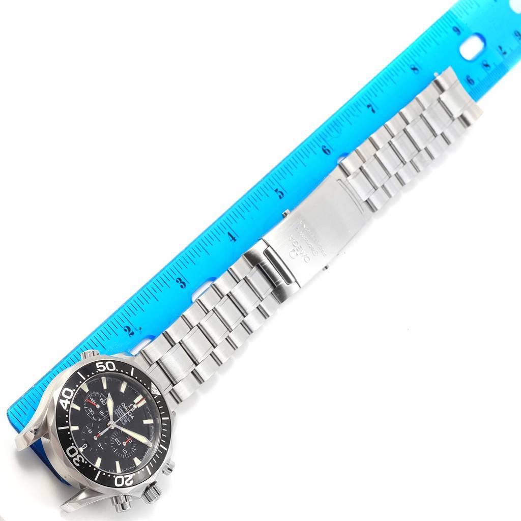 The image shows an aerial view of an Omega Seamaster 2594.52.00 Men
s Stainless Steel Black Dial 2594.52.00 Men
s Stainless Steel Black Dial watch with its full metal bracelet and a blue ruler for scale.