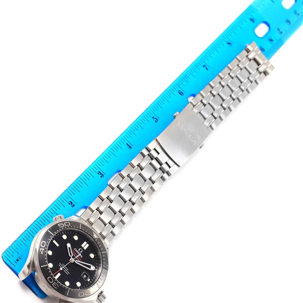 This image shows an Omega Seamaster 212.30.41.20.01.003 Men
s Stainless Steel Black Dial 212.30.41.20.01.003 Men
s Stainless Steel Black Dial watch with a metal bracelet fully extended next to a blue ruler for measurement.