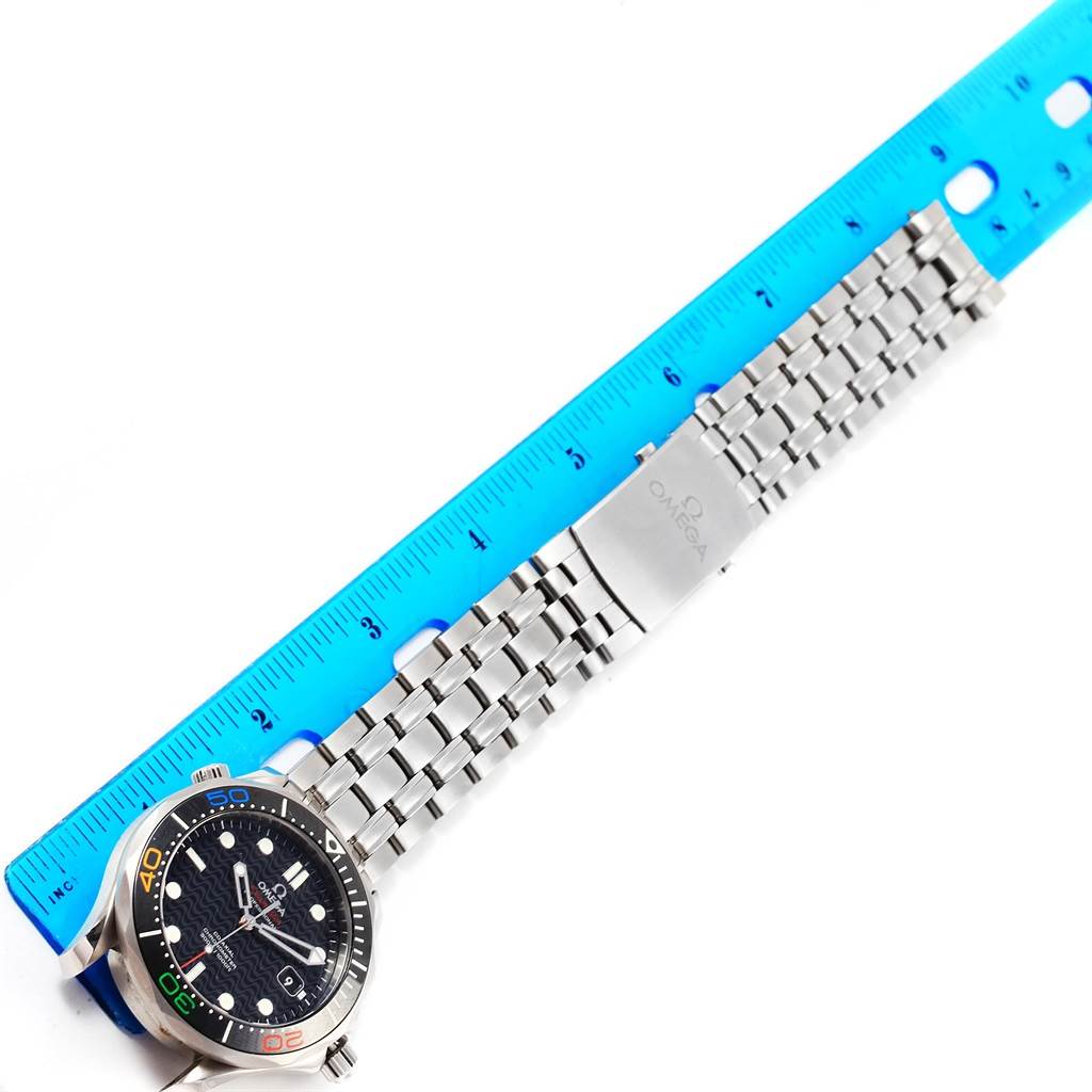 The image shows an Omega Seamaster 522.30.41.20.01.001 Men
s Stainless Steel Black Dial 522.30.41.20.01.001 Men
s Stainless Steel Black Dial watch with a blue dial and stainless steel bracelet next to a blue ruler for scale.