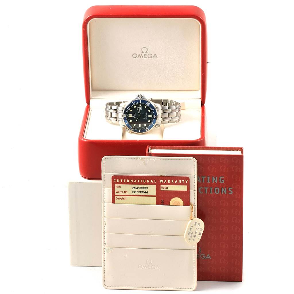 The Omega Seamaster 2541.80.00 Men
s Stainless Steel Blue Dial 2541.80.00 Men
s Stainless Steel Blue Dial watch is shown in its open case, along with an international warranty card and an operating instructions booklet.