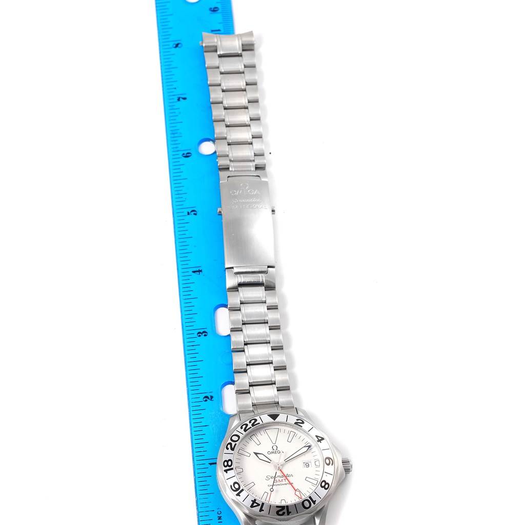 The image shows an Omega Seamaster 2538.20.00 Men's Stainless Steel White Dial 2538.20.00 Men's Stainless Steel White Dial watch laid flat beside a blue ruler, displaying both the watch face and metal band.