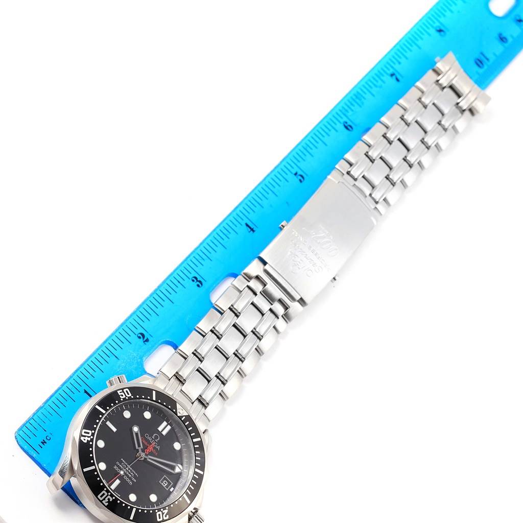 The image shows the face and metal bracelet of an Omega Seamaster 212.30.41.20.01.001 Men's Stainless Steel Black Dial 212.30.41.20.01.001 Men's Stainless Steel Black Dial watch, laid next to a blue ruler.