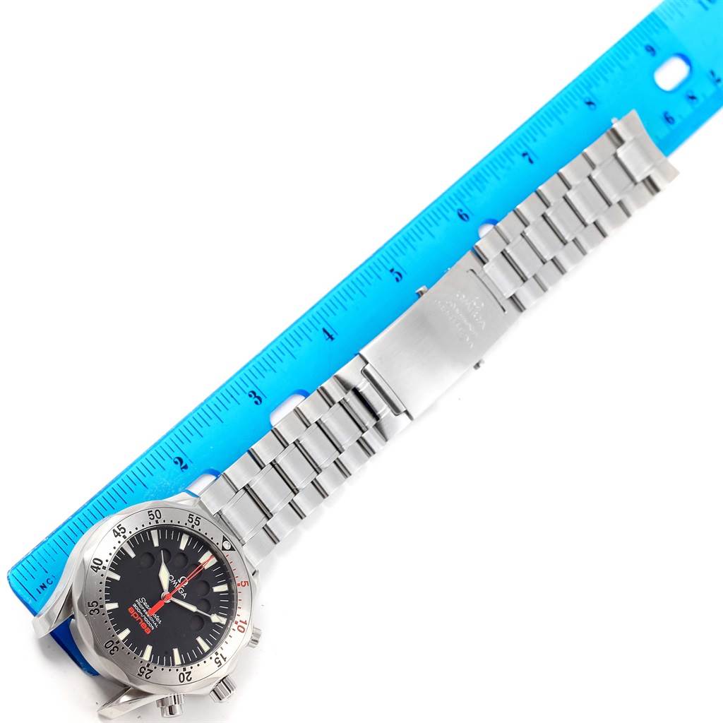 The Omega Seamaster 2595.50.00 Men
s Stainless Steel Black Dial 2595.50.00 Men
s Stainless Steel Black Dial watch is displayed from a top-down angle, showing its full metal bracelet, clasp, and face alongside a ruler for scale.