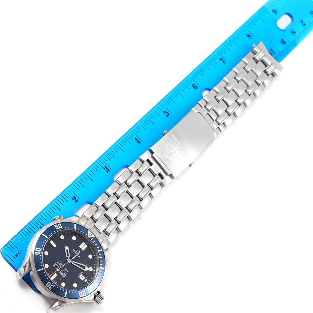 The Omega Seamaster 2531.80.00 Men
s Stainless Steel Blue Dial 2531.80.00 Men
s Stainless Steel Blue Dial watch is shown from a top-down angle, displaying the face, bezel, bracelet, and clasp, alongside a blue ruler for scale.