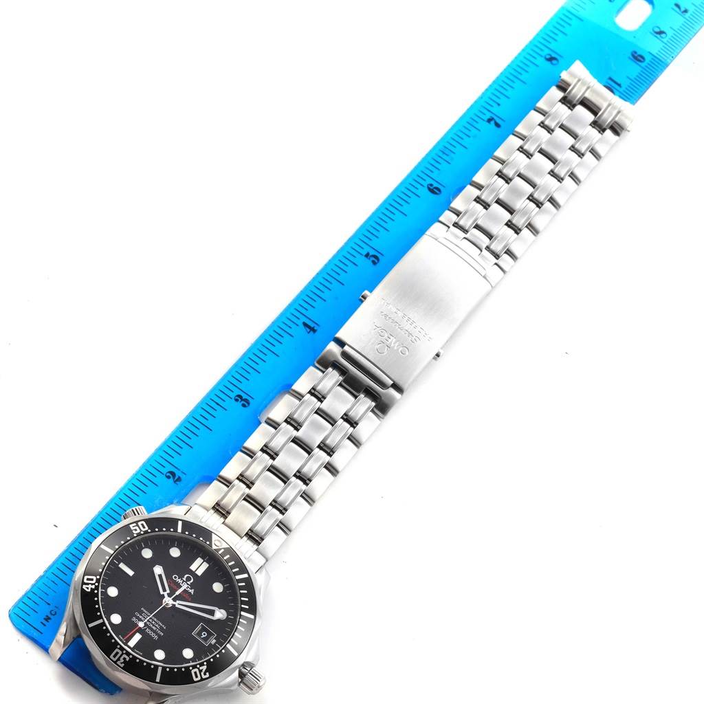 The Omega Seamaster 212.30.41.20.01.002 Men
s Stainless Steel Black Dial 212.30.41.20.01.002 Men
s Stainless Steel Black Dial watch is shown flat with a metal bracelet band and placed alongside a blue ruler for scale.