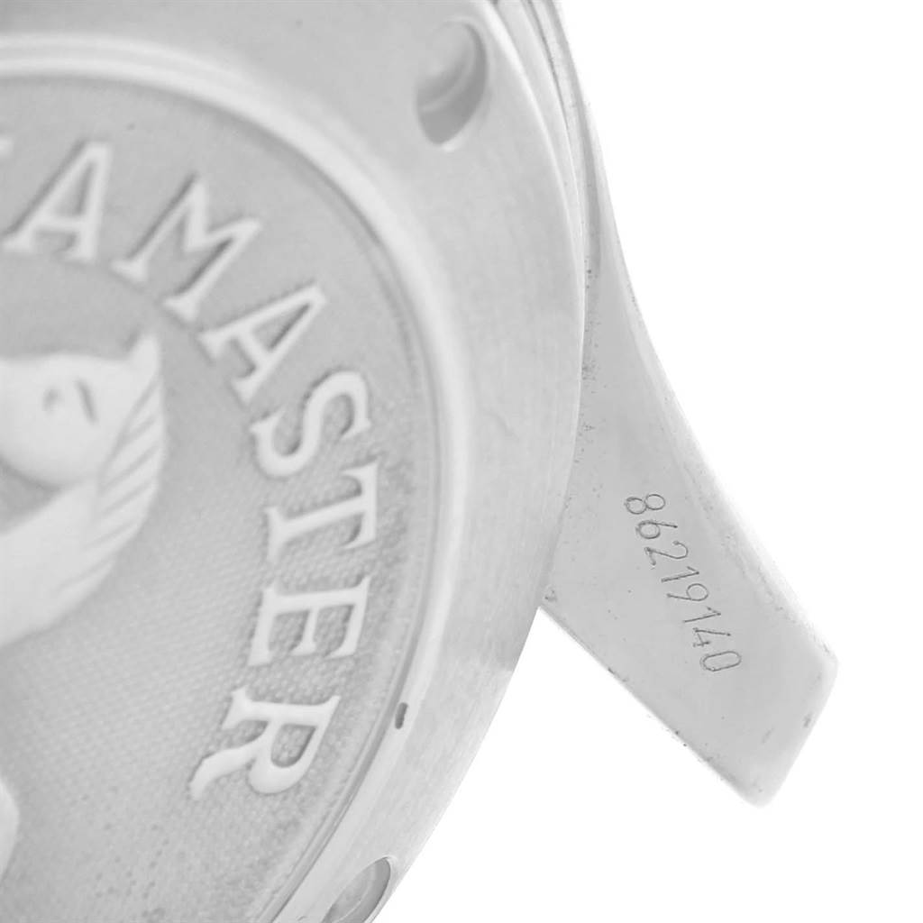 The image shows a close-up of the back case of an Omega Seamaster 2225.80.00 Men
s Stainless Steel Blue Dial 2225.80.00 Men
s Stainless Steel Blue Dial watch, highlighting part of the engraved lettering and a serial number.