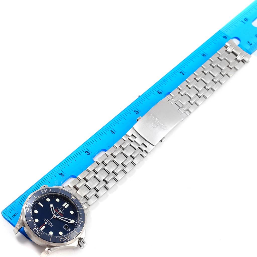 This image shows the Omega Seamaster 212.30.41.20.03.001 Men
s Stainless Steel Blue Dial 212.30.41.20.03.001 Men
s Stainless Steel Blue Dial watch laid flat on a blue ruler, highlighting its face, bracelet, and clasp.