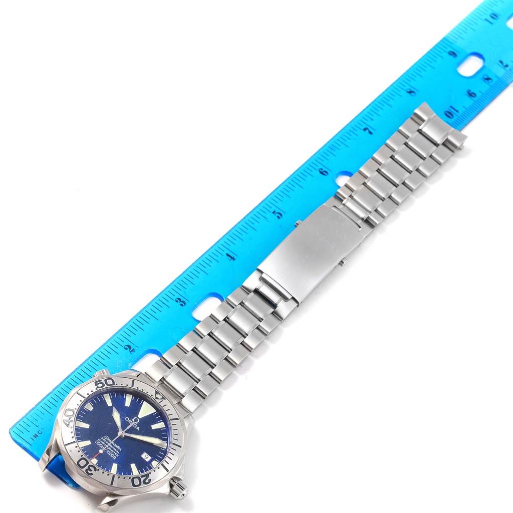 This image shows an Omega Seamaster 2255.80.00 Men
s Stainless Steel Blue Dial 2255.80.00 Men
s Stainless Steel Blue Dial watch laid flat with a ruler, highlighting the face, bezel, and metal bracelet.