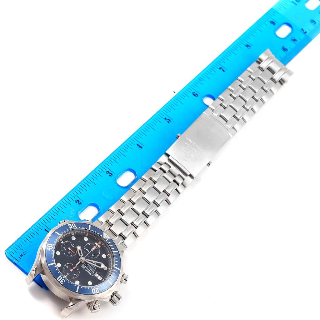 The image shows an Omega Seamaster 2599.80.00 Men
s Stainless Steel Blue Dial 2599.80.00 Men
s Stainless Steel Blue Dial watch laid flat with a ruler, displaying the front dial and metal strap.