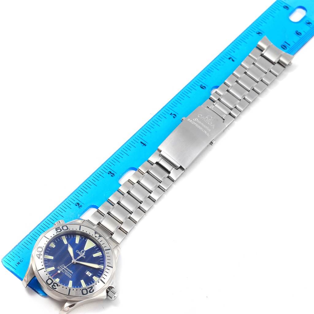 The image shows a top-down view of the Omega Seamaster 2265.80.00 Men
s Stainless Steel Blue Dial 2265.80.00 Men
s Stainless Steel Blue Dial watch, highlighting its face, bezel, bracelet, and clasp against a ruler.