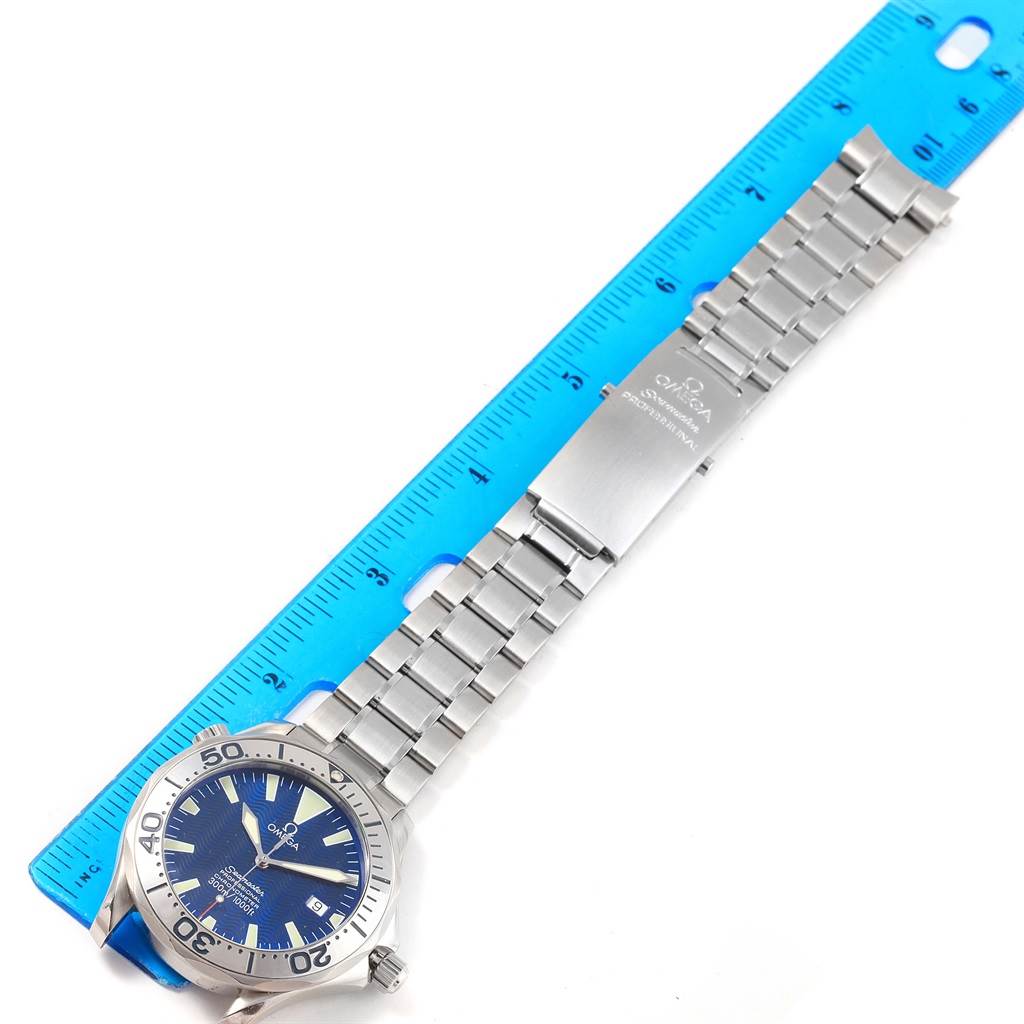 The Omega Seamaster 2255.80.00 Men
s Stainless Steel Blue Dial 2255.80.00 Men
s Stainless Steel Blue Dial watch is shown laid flat with a close-up of its face, metal bracelet, and clasp against a ruler for scale.