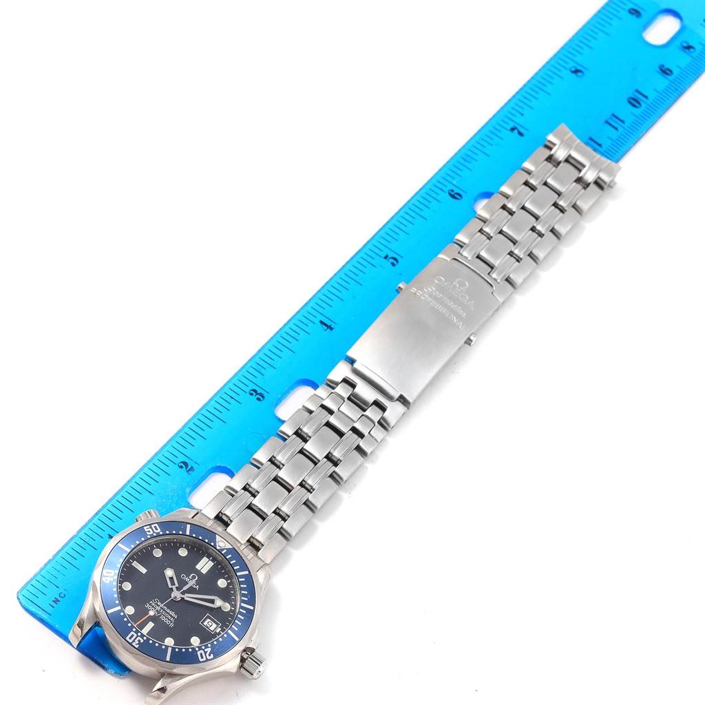 The image shows a top-down view of an Omega Seamaster 2561.80.00 Men
s Stainless Steel Blue Dial 2561.80.00 Men
s Stainless Steel Blue Dial watch, including the dial, bezel, and bracelet extended next to a ruler.