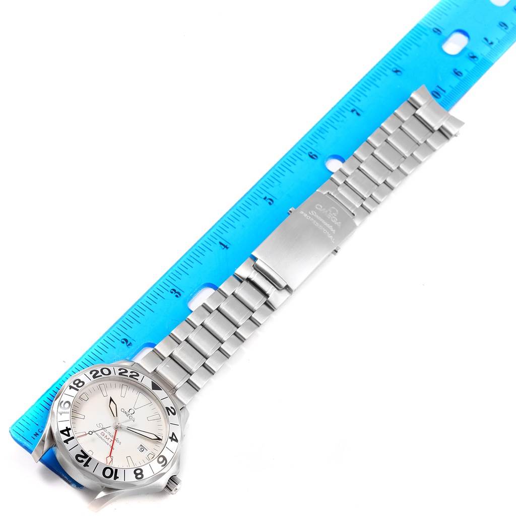 The image shows an Omega Seamaster 2538.20.00 Men's Stainless Steel White Dial 2538.20.00 Men's Stainless Steel White Dial watch laid flat next to a blue ruler, displaying the face, metal bracelet, and clasp.