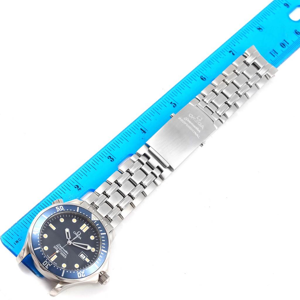 The image shows a top-down view of an Omega Seamaster 2541.80.00 Men
s Stainless Steel Blue Dial 2541.80.00 Men
s Stainless Steel Blue Dial watch, including its face, bezel, bracelet, and clasp, with a ruler for scale.