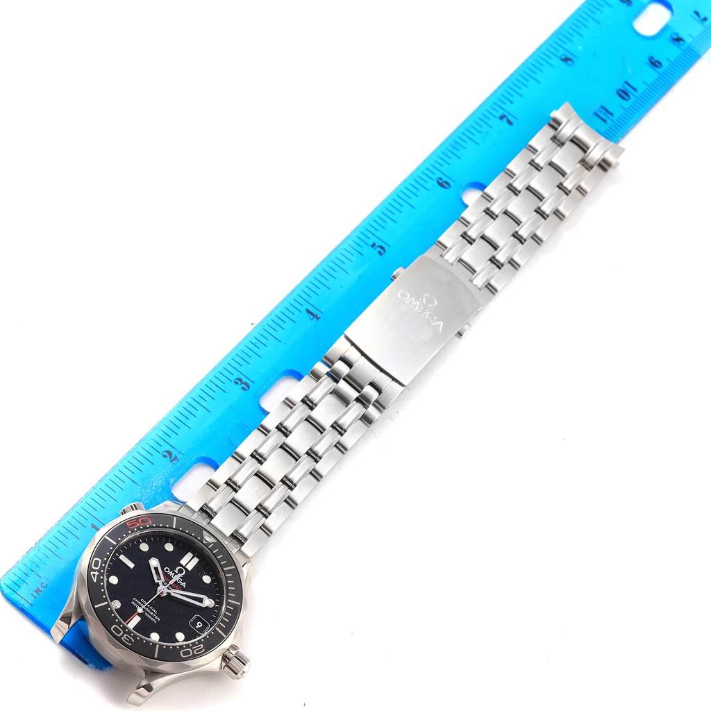 The image shows an Omega Seamaster 212.30.36.20.51.001 Men's Stainless Steel Black Dial 212.30.36.20.51.001 Men's Stainless Steel Black Dial watch displayed flat, with its stainless steel band aligned against a blue ruler.