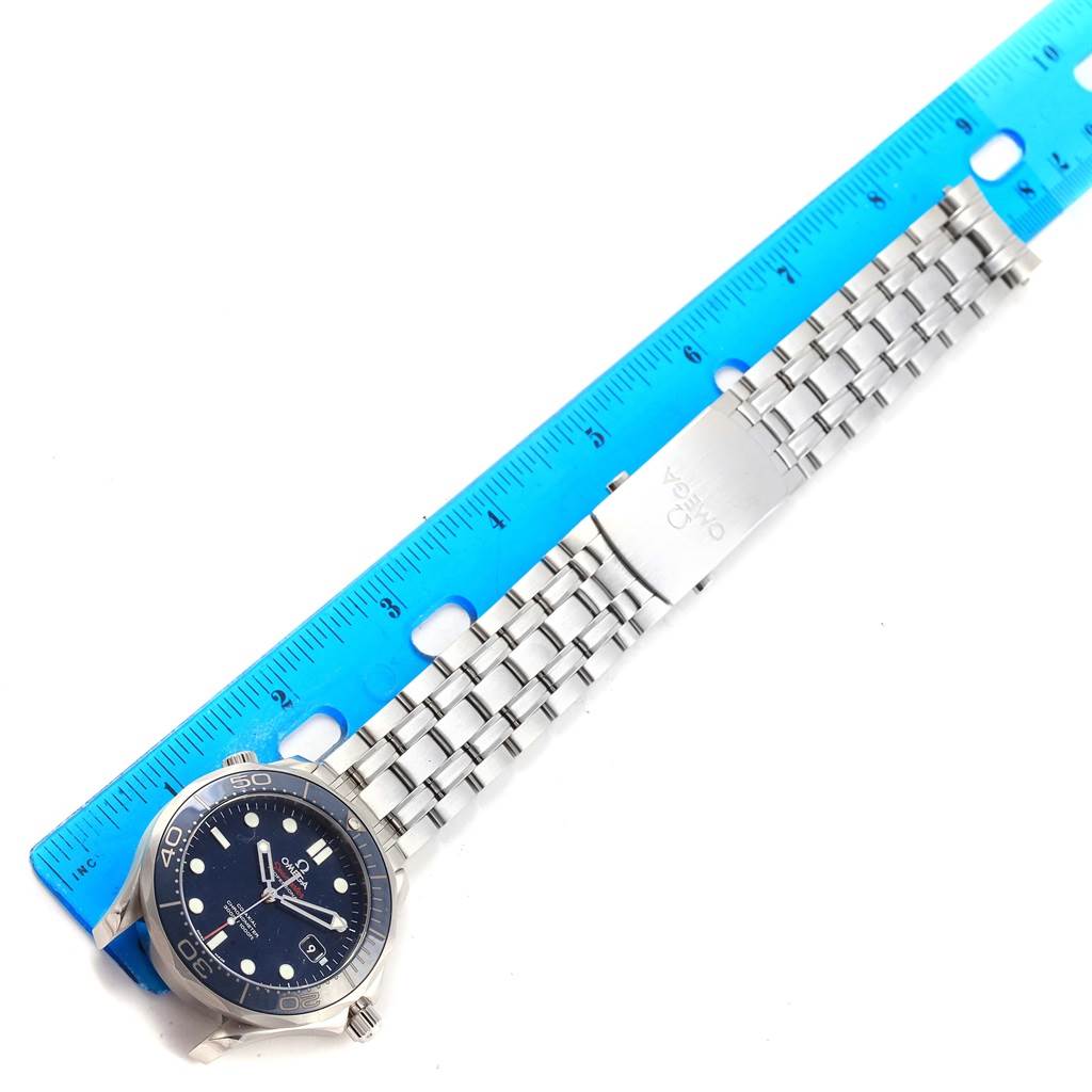 The image shows an Omega Seamaster 212.30.41.20.03.001 Men
s Stainless Steel Blue Dial 212.30.41.20.03.001 Men
s Stainless Steel Blue Dial watch laid flat, with a blue ruler measuring its length.