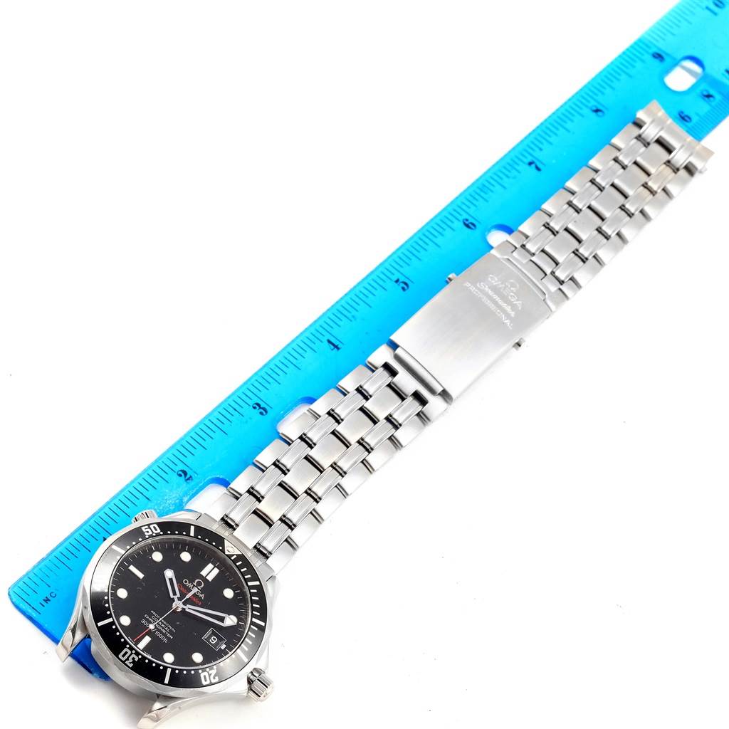 The image shows an Omega Seamaster 212.30.41.20.01.002 Men
s Stainless Steel Black Dial 212.30.41.20.01.002 Men
s Stainless Steel Black Dial watch from a top-down angle, displaying the watch face, bezel, bracelet, and clasp near a ruler.