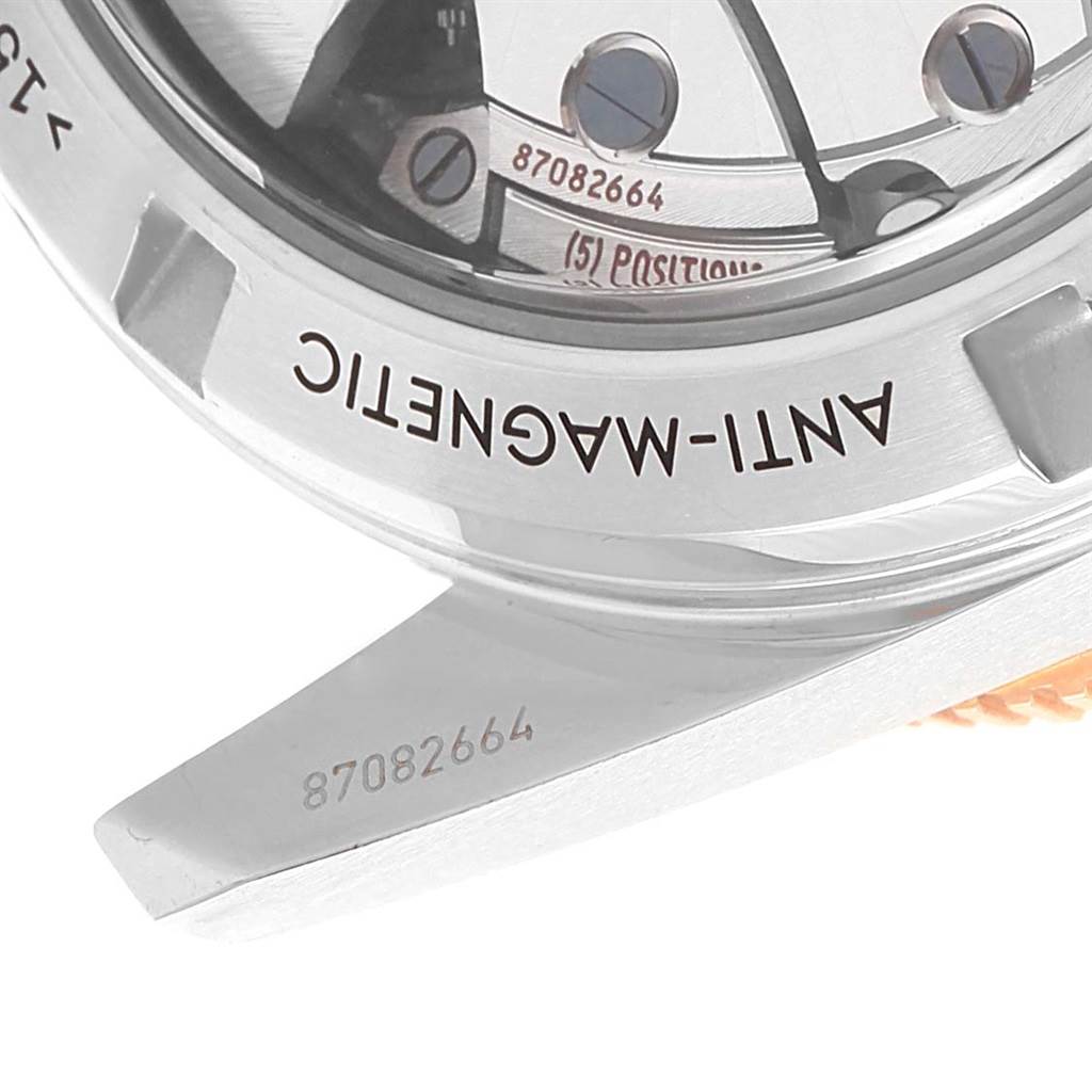 The image shows the back of an Omega Seamaster 233.20.41.21.01.001 Men's Steel and Gold (two tone) Black Dial 233.20.41.21.01.001 Men's Steel and Gold (two tone) Black Dial watch, highlighting the anti-magnetic marking and serial number on the case.