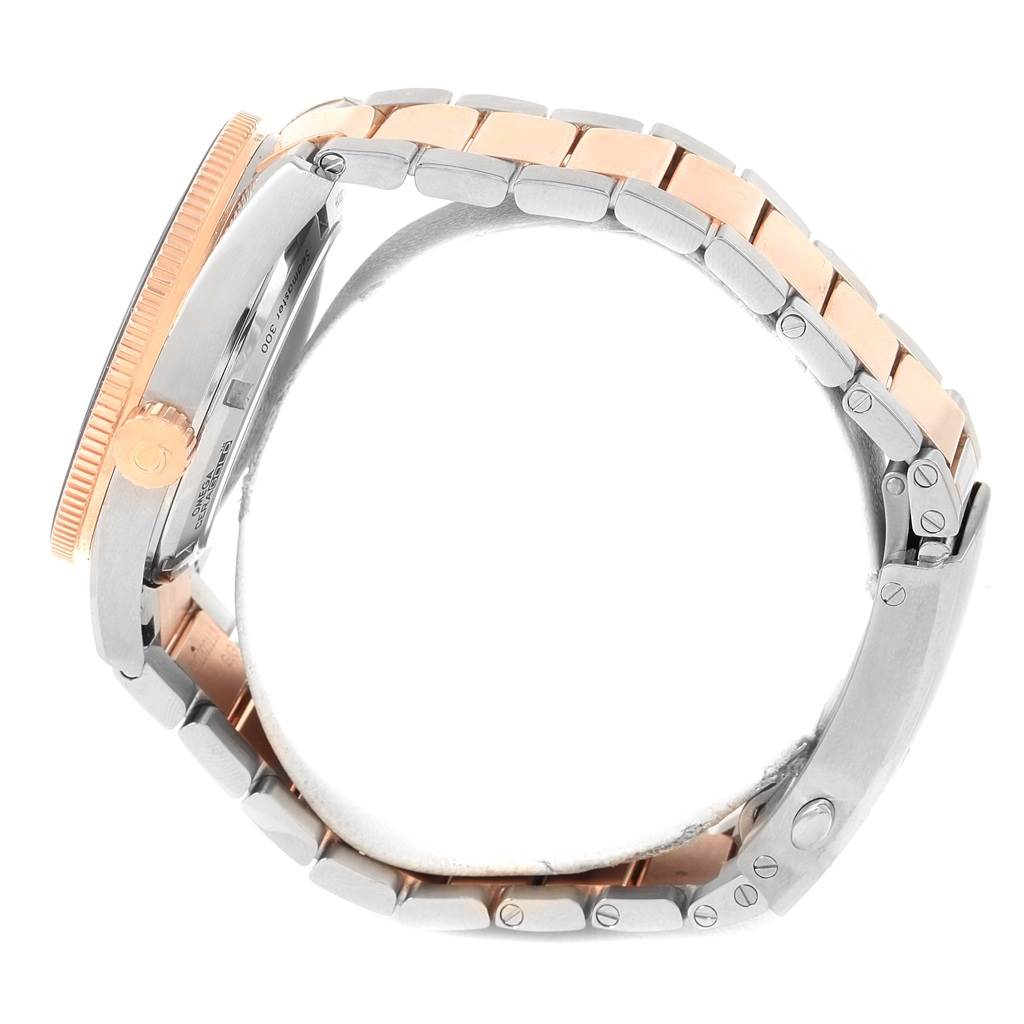 This image shows a side view of the Omega Seamaster 233.20.41.21.01.001 Men's Steel and Gold (two tone) Black Dial 233.20.41.21.01.001 Men's Steel and Gold (two tone) Black Dial watch, highlighting the bezel, crown, and two-tone bracelet.