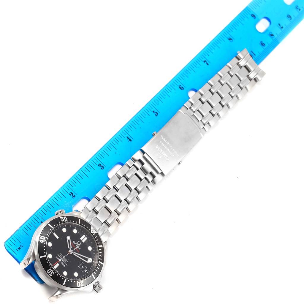 This Omega Seamaster 212.30.41.20.01.002 Men's Stainless Steel Black Dial 212.30.41.20.01.002 Men's Stainless Steel Black Dial watch is shown from a top-down angle, displaying the face and metal bracelet against a blue ruler.