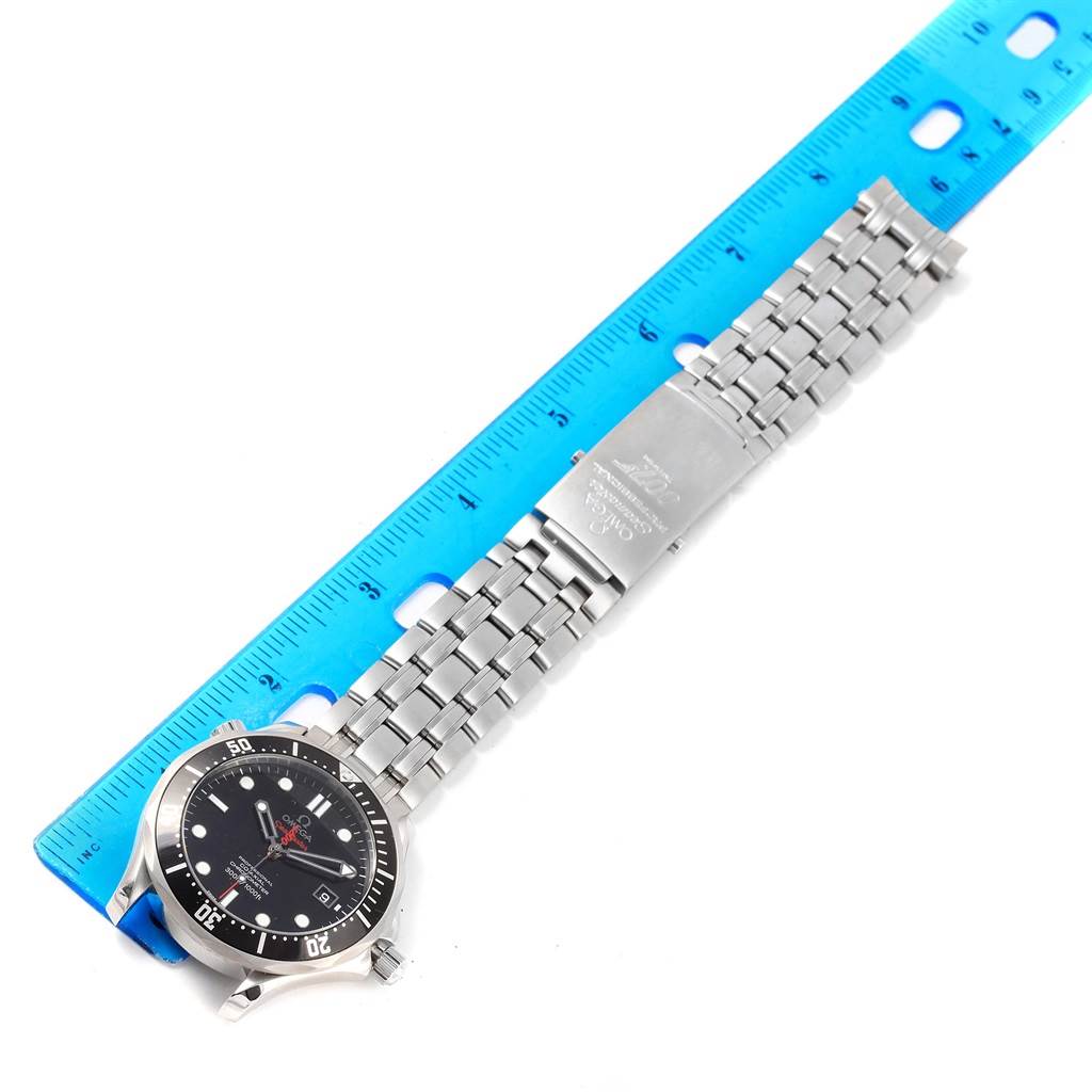 The image shows an Omega Seamaster 212.30.41.20.01.001 Men's Stainless Steel Black Dial 212.30.41.20.01.001 Men's Stainless Steel Black Dial watch laid flat next to a blue ruler, highlighting its face and stainless steel bracelet.