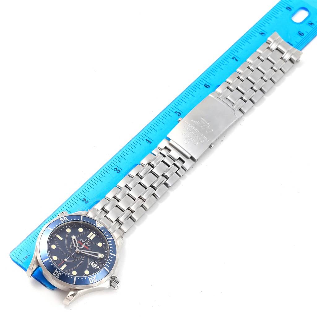 The image shows a top-down view of an Omega Seamaster 2226.80.00 Men's Stainless Steel Blue Dial 2226.80.00 Men's Stainless Steel Blue Dial watch, highlighting its dial and bracelet laid next to a ruler.