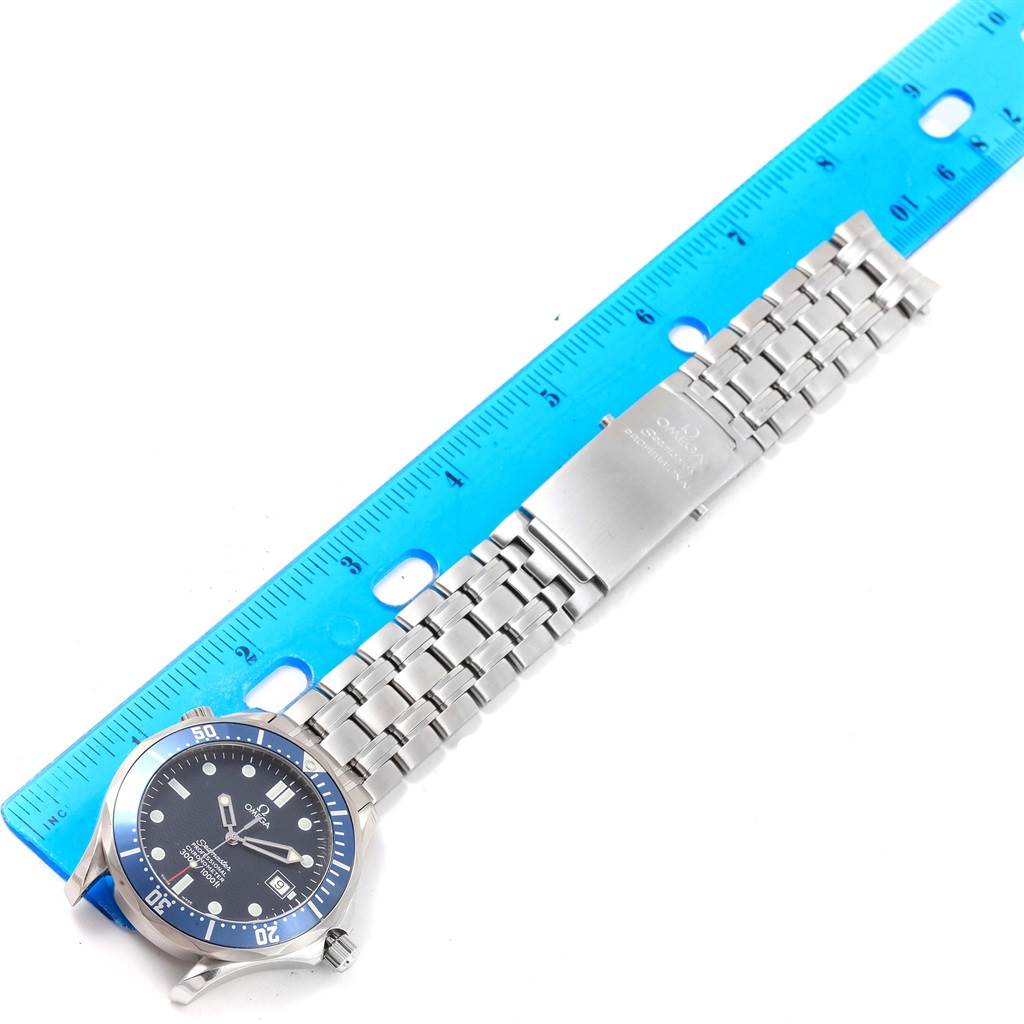 The Omega Seamaster 2531.80.00 Men
s Stainless Steel Blue Dial 2531.80.00 Men
s Stainless Steel Blue Dial watch is shown from a top-down angle, displaying the face, bezel, bracelet, and clasp alongside a ruler.