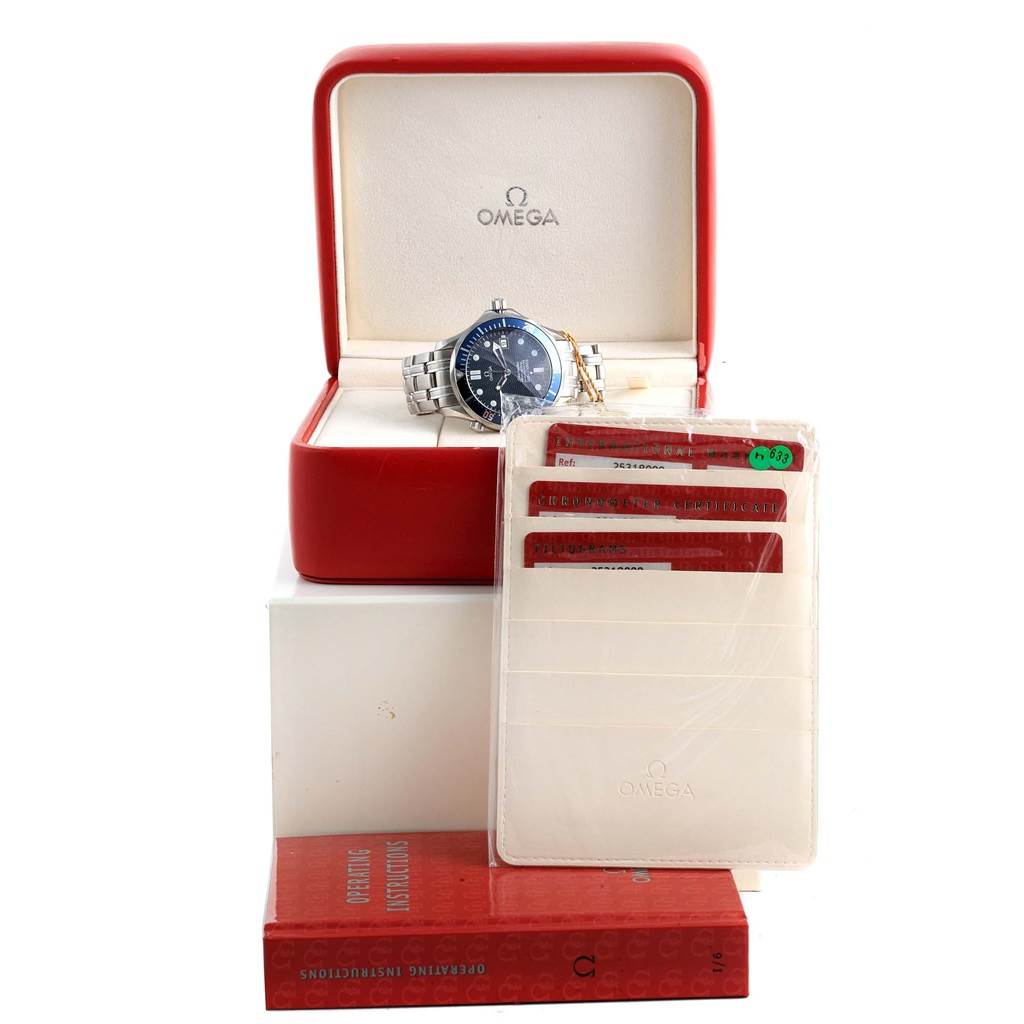 The image shows an Omega Seamaster 2531.80.00 Men
s Stainless Steel Blue Dial 2531.80.00 Men
s Stainless Steel Blue Dial watch in its red case, along with documentation and operating instructions.